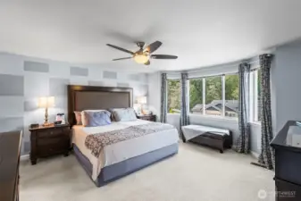 Spacious primary with bay windows.