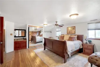 Vintage hardwood floor in this Primary Suite on the second floor . In room vanity in addition to a full bathroom