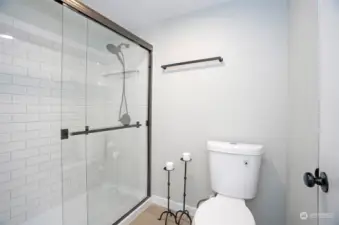 The primary bath features a beautifully tiled walk-in shower. Elegant yet functional.