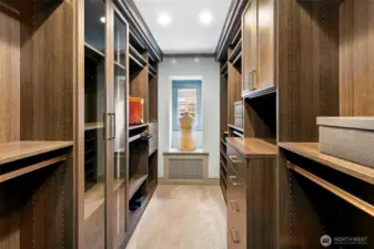 The Wardrobe/Dressing room of the Owner’s Suite delivers boutique-caliber luxury with rich wood finishes, custom shelving, and gallery-style lighting. An elegant passage between private quarters and en suite bath, it’s a daily ritual rendered extraordinary.