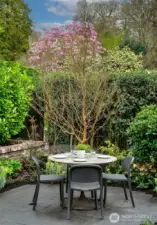 Tucked within the Grilling Terrace, this intimate Outdoor Dining area is a private pocket of calm framed by flowering trees and manicured hedges. Whether for morning coffee or twilight suppers, it offers a lush backdrop for everyday rituals made extraordinary.