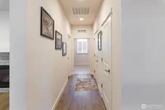 Hallway leads to guest bathroom and utility room.