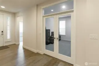 Entry showing access to second bedroom with en suite.  French doors lead to den.