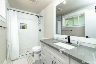 Primary bathroom with walk-in tiled shower