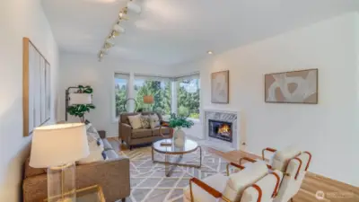 Open concept living and dining areas anchored by two gas fireplaces, one on each side.