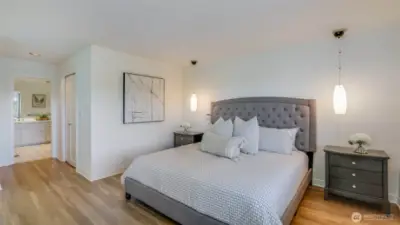Upstairs, the serene primary suite offers a sitting area, spa-inspired bath, and walk-in closet.