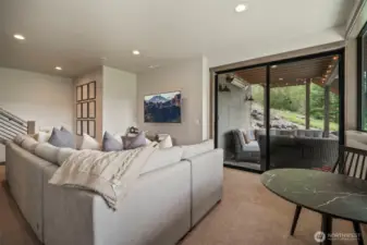 Step through the sliding glass door to access a wonderful covered outside gathering area and have easy access to the hot tub and lawn area