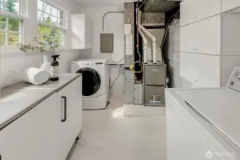 Utility room with a newer HVAC and many storage cabinetary.