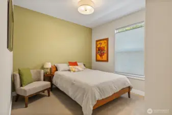 Inviting Guest Retreat – Freshly painted with a soothing green accent wall, this comfortable guest bedroom offers plush carpet, a large window for natural light, and ample space for a queen bed and seating. Perfect for visitors, a home office, or flex space.