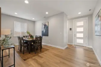 Dining & Entry View – Showcasing a seamless flow from the modern front door to the formal dining area, this bright space features wood-style floors and recessed lighting for a warm, contemporary welcome.