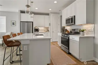 Gourmet Kitchen – Bright and modern with quartz countertops, stainless steel appliances, a gas range, and large island with seating. Perfect for cooking, entertaining, and everyday living.