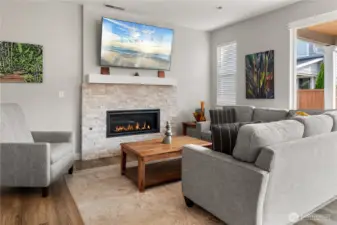 Inviting Living Room – Warm and bright with a stacked-stone gas fireplace and plenty of natural light, this comfortable space is perfect for relaxing or entertaining.