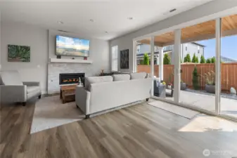 Indoor-Outdoor Living – Expansive sliding glass doors fill the great room with natural light and open to the covered patio and fully fenced backyard, ideal for entertaining or relaxing year-round.