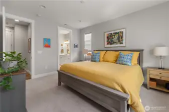 Primary Suite with En-Suite Bath – Generous bedroom with plush carpet and natural light, opening to a private bathroom with dual sinks for everyday convenience.