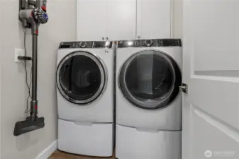 Laundry Room with Storage – Convenient laundry space with upper cabinets and easy-care flooring. Washer and dryer not included.