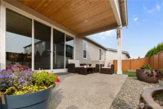 Covered Outdoor Living – Spacious concrete patio with overhead cover and room for seating or dining, perfect for year-round relaxation and entertaining.