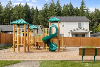 Community Playground – Neighborhood play area with swings, slides, and climbing structures, offering fun and convenience for homeowners.
