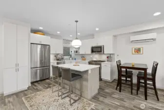 Island with breakfast bar and dining area