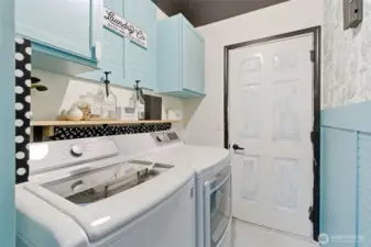 Designated laundry room leads to garage