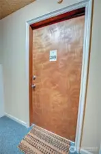 Door to unit 209 -- interior entrance to unit.