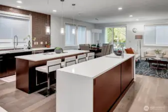 The gourmet kitchen features two spacious islands, including an eat-in island and a separate Chef's prep island.