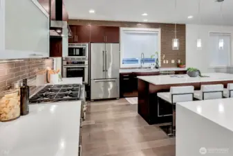 The gourmet kitchen features all high-end appliances.