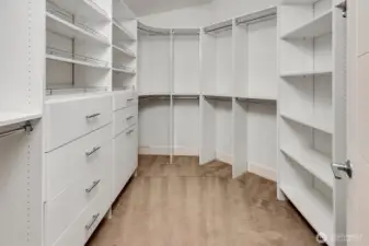 An adjacent walk-in closet with California Closets.