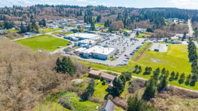 Aerial view with shopping center in front of the house.