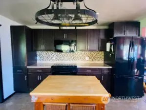 Look at all those cabinets! Updated light fixture and built-in microwave.