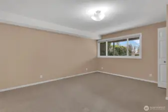 Second primary suite on the lower level with window to the front yard/gardens. This suite has 2 walk in closets for storage and an ensuite bathroom.