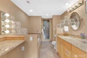 Ensuite bathroom with plenty of counter space and cabinets, as well as heated floors.