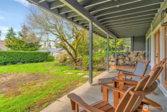 Lower level patio underneath the deck with french doors to the lower level living space.  There are pavers leading to the front walkway.