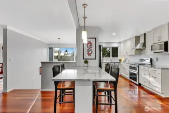 Kitchen has island/eating bar for informal dining, and ample cabinets for storage.