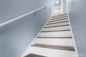 Hand crafted staircase leads up to two bedrooms and another full bathroom.