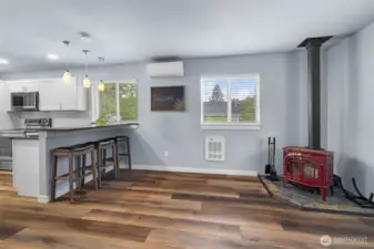 Free standing wood fireplace brings ambiance and winter warmth to the open concept floor plan.