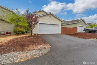 Alley view of the elongated driveway and two car garage