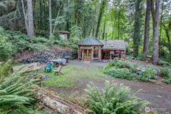 This is looking down upon the home, circular driveway, picnic area, fire pit and up on the hill is the sauna - currently used as storage for now.