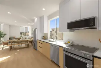 Large kitchen area with sleek cabinets and beautiful backsplash