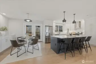A seamless transition between kitchen and dining makes this space feel expansive, bright and ideal for entertaining.