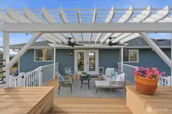 An inviting covered sitting area just off of the kitchen and dining rooms -- complete with ceiling fans for summer breezes.