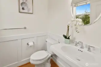 The main-floor guest bathroom features a classic pedestal sink and clean, tasteful finishes.