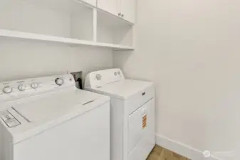 Convenient laundry area tucked away with ample pantry space nearby for all your household essentials.