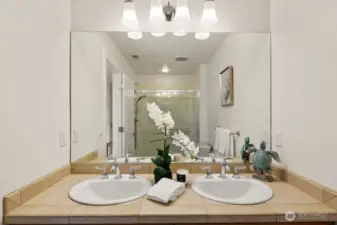 A bright, airy en suite bathroom completes the primary suite for a true spa-at-home feel.