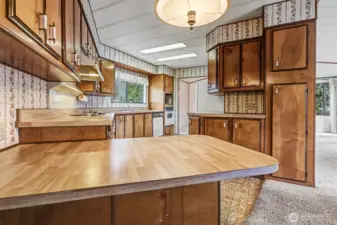 Spacious kitchen with plenty of counter and cabinet space and an eating bar opens to the family room.