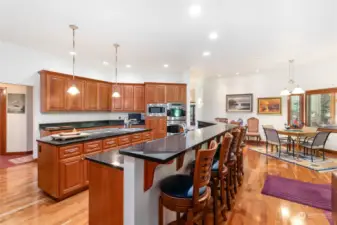 Off in the distance of this kitchen view is another great eating space for your large crowd. Did I mention this kitchen was designed with entertainment in mind?!