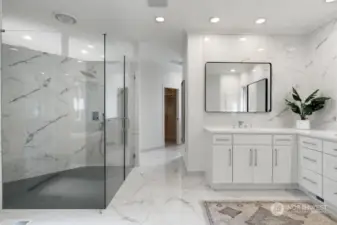 Huge walk-in designer tiled shower with rain shower head.