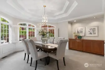 The large octagon shaped formal dining room is off the kitchen through a barrel ceiling alcove and features triple crown molding, wainscoting, built-in cherry buffet and separate butler’s pantry with sink, cherry cabinets and wine refrigerator.