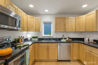 Custom designed, quality built, and thoughtfully installed, these shaker cabinets and granite counters are straight out of your dreams!