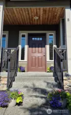 Enjoy this front porch stoop!  Cheery Porch to greet your guests!