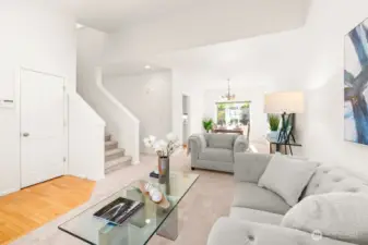 Light filled living and dining rooms are virtually staged